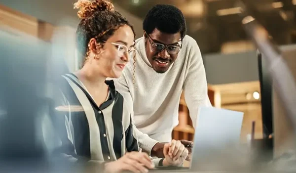 Two colleagues collaborating at a computer