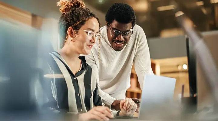 Two colleagues collaborating at a computer