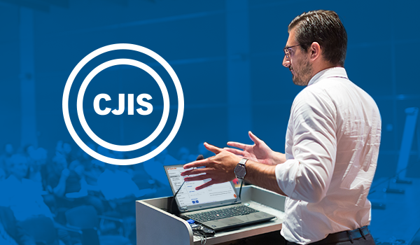 Speaker at podium with CJIS logo on blue background